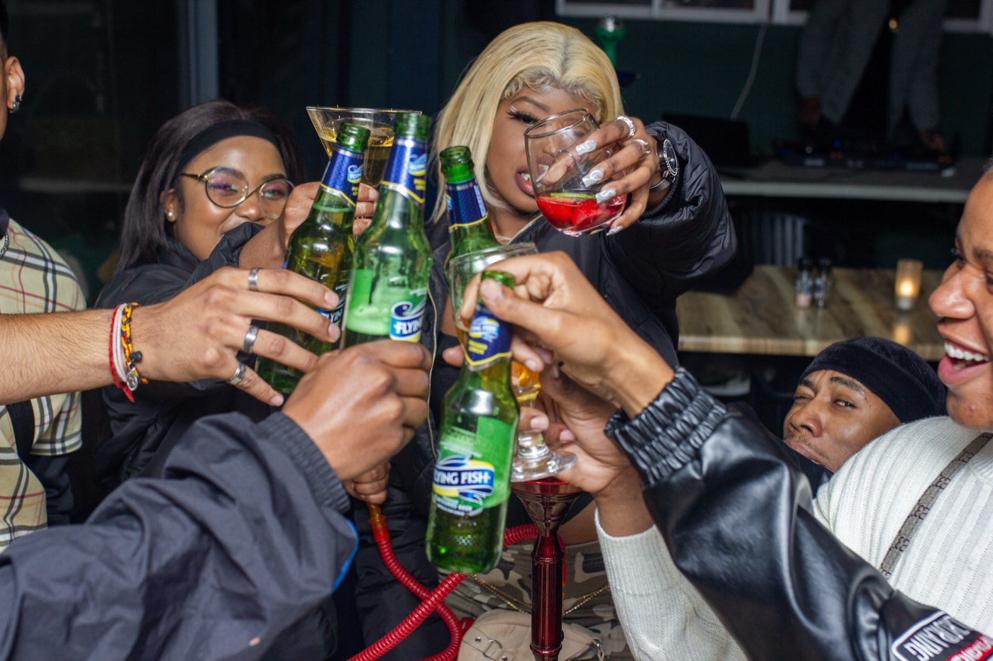 Friends raising a toast on a Melville night out — the kind of moment the vault keeps